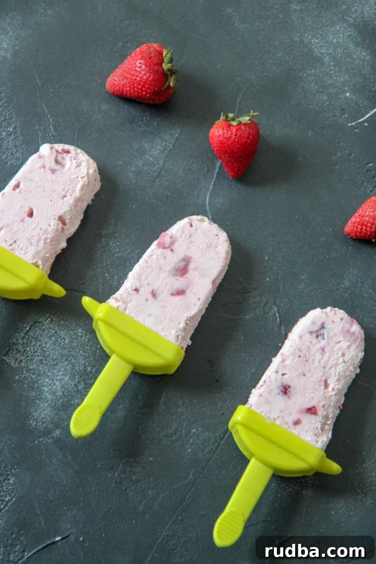 strawberry cheesecake popsicles with strawberry chunks