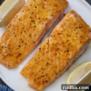 Two baked lemon pepper salmon fillets.