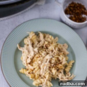 Easy Creamy Slow Cooker Chicken Pasta 2 crockpot creamy chicken pasta on a plate.