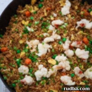 Luxe Lobster Grains 2 Lobster fried rice in a black skillet.