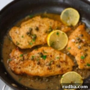 Zesty Lemon Chicken Piccata 2 three chicken breasts piccata in a skillet with sauce and lemon slices.