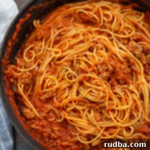Hearty Turkey Spaghetti 2 ground turkey spaghetti in a black skillet.