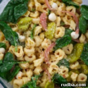 Zesty Tortellini Pasta Salad 2 tortellini pasta salad in a glass bowl.