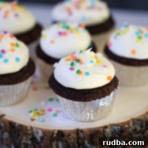 Ultimate Chocolate Cupcakes with Tangy Cream Cheese Frosting 2 Six chocolate cupcakes with cream cheese frosting and sprinkles.