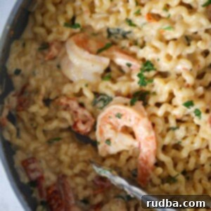 Sun-Kissed Tuscan Shrimp Pasta 2 Tuscan shrimp pasta in a skillet up close.