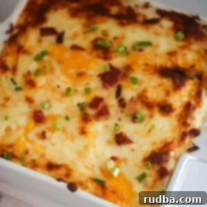 Crack chicken dip in an 8x8 white baking dish, ready for serving.