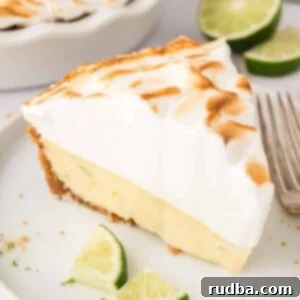 A slice of key lime pie with meringue on top.