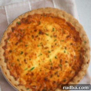 Triple Cheese Quiche Delight 2 Three cheese quiche on a pink and white towel.