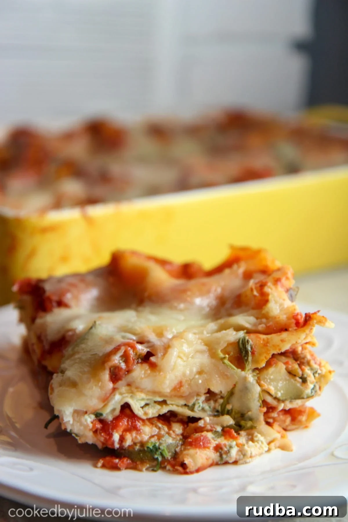 Classic, cheesy vegetable lasagna with golden brown crust and fresh herbs