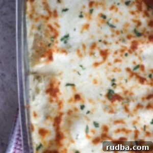 white chicken enchiladas in a 9x13 baking dish.