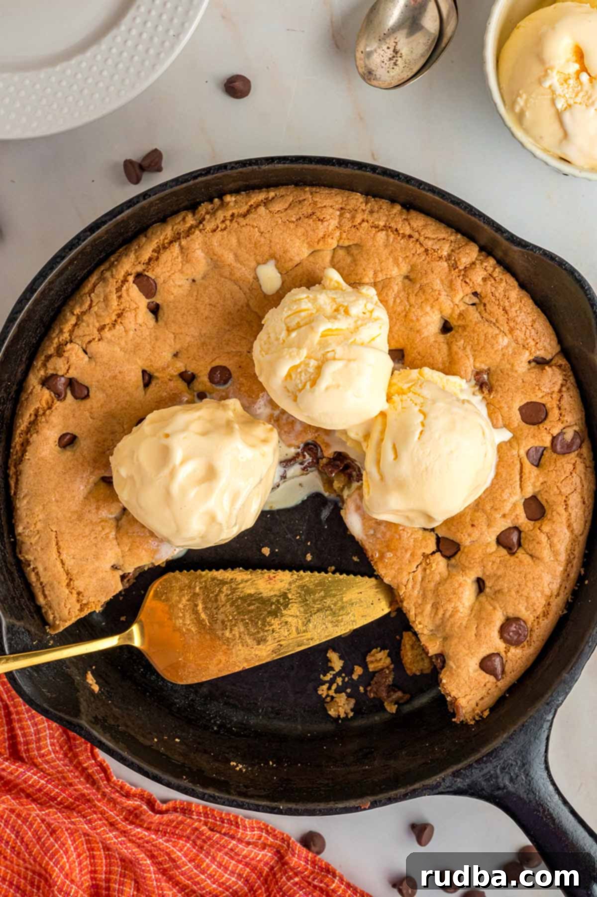 Chocolate chip cookie skillet with three scoops of vanilla ice cream.