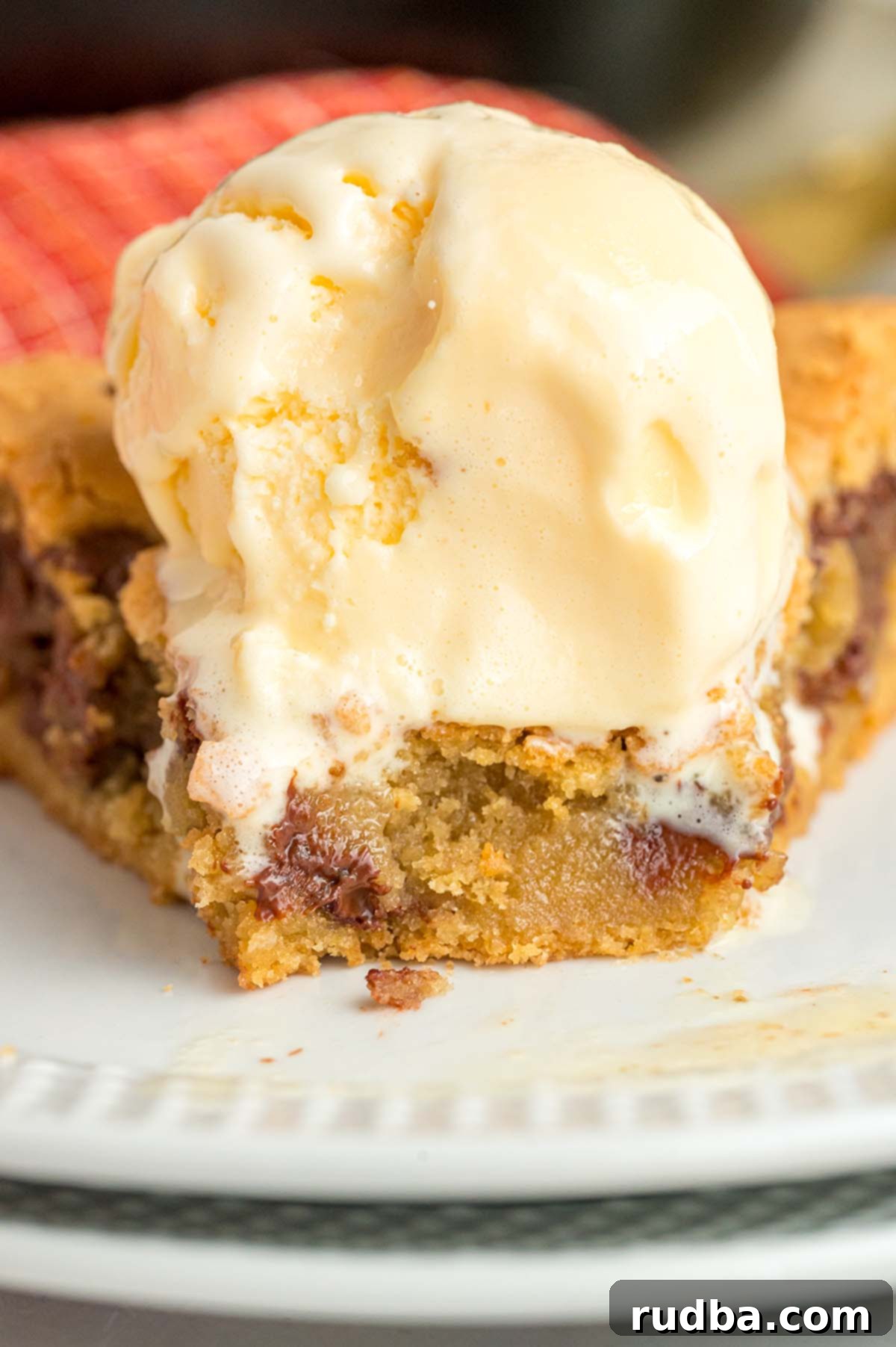 Cookie with vanilla ice cream on top.