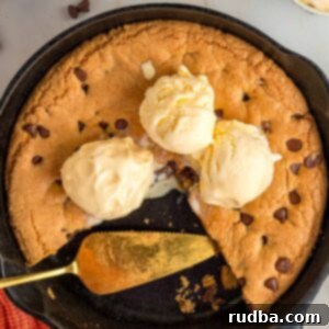 Chocolate chip cookie skillet with three scoops of vanilla ice cream.
