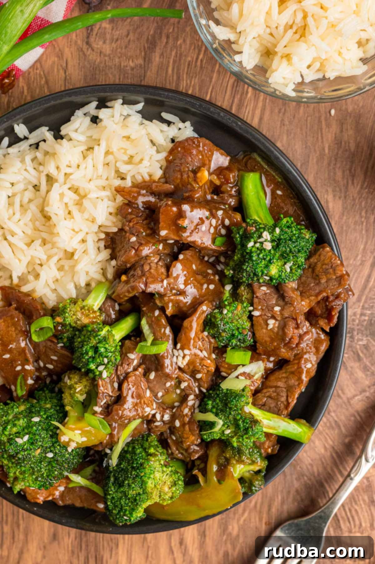 Classic Beef and Broccoli Stir Fry 2 Delicious beef and broccoli stir-fry served with fluffy white rice on a plate.