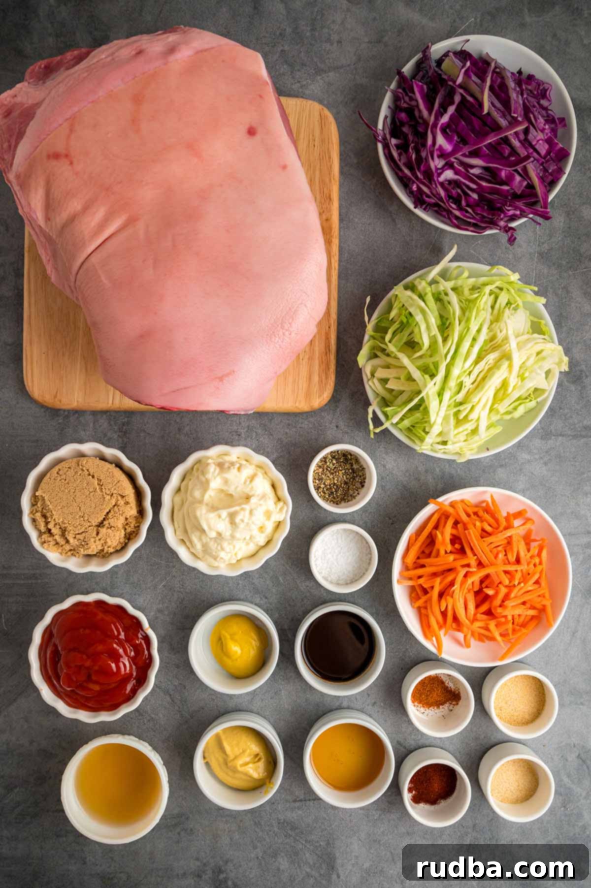 A selection of fresh ingredients including pork shoulder, cabbage, carrots, and various BBQ sauce components laid out for making pulled pork sandwiches.