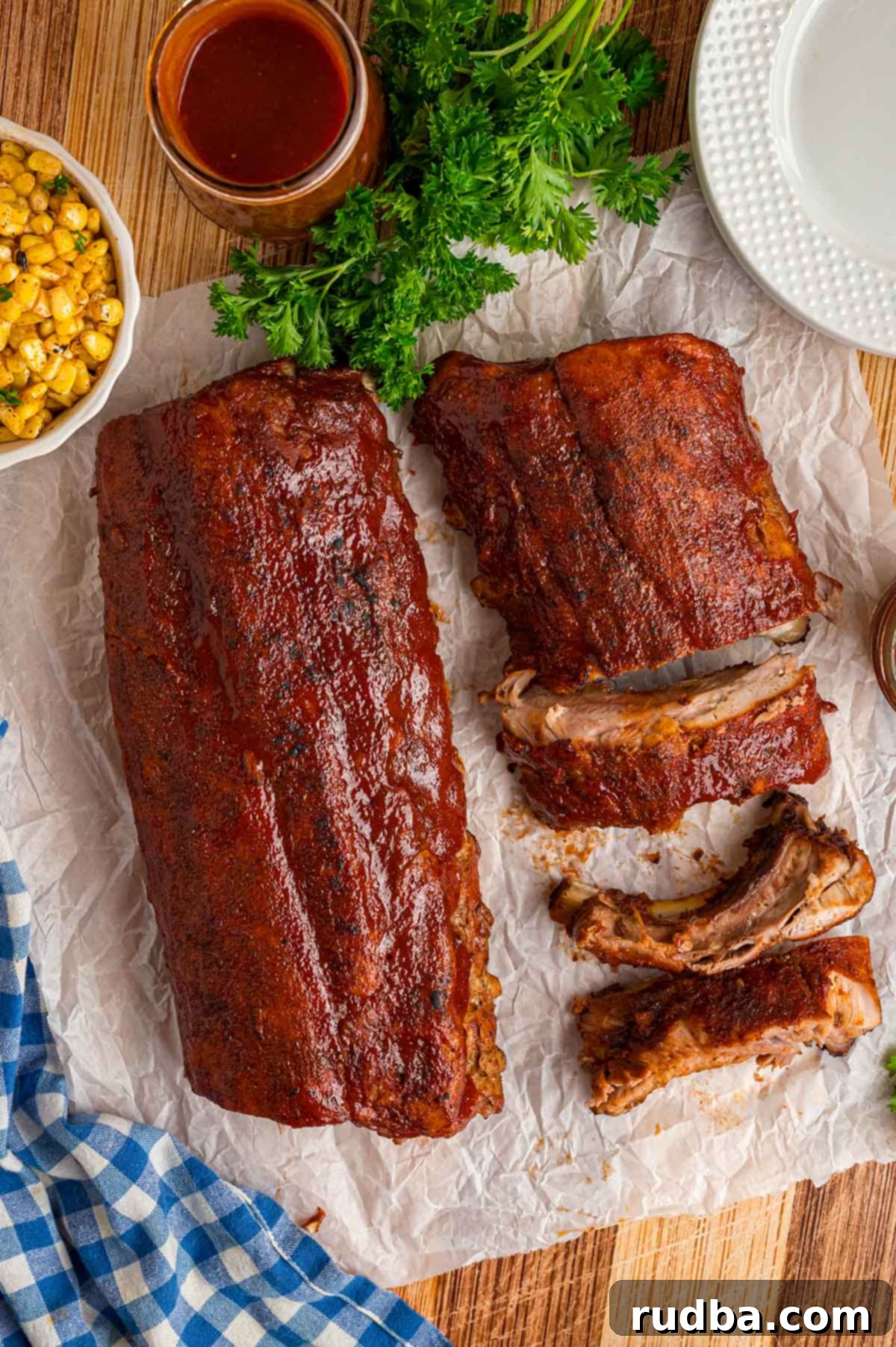 Ultimate Oven Baked BBQ Ribs 2 Two pork rib slabs with bbq sauce on top.