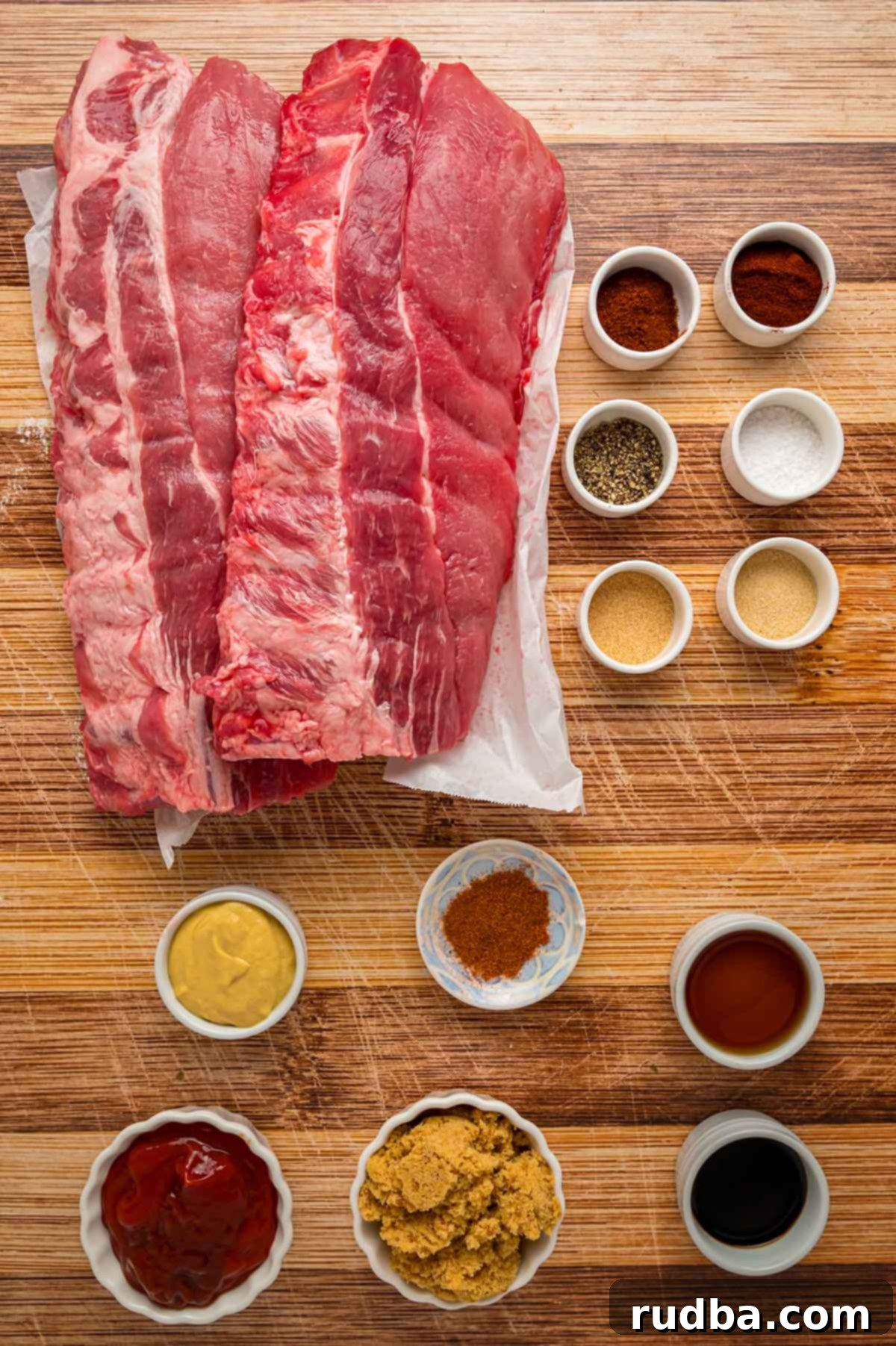 Ultimate Oven Baked BBQ Ribs 3 Ingredients on a wooden board.