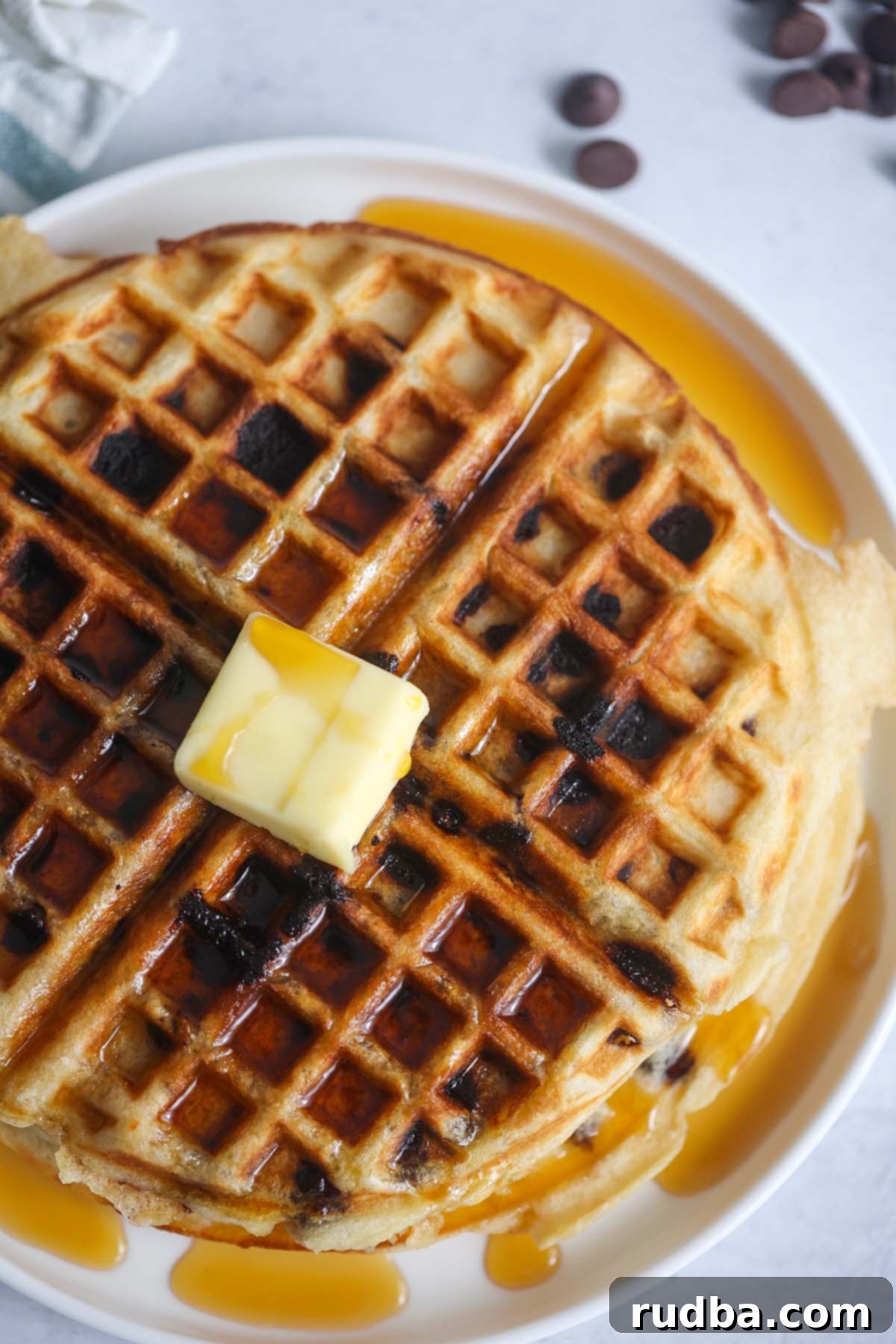Chocolate chip waffle with butter and syrup.