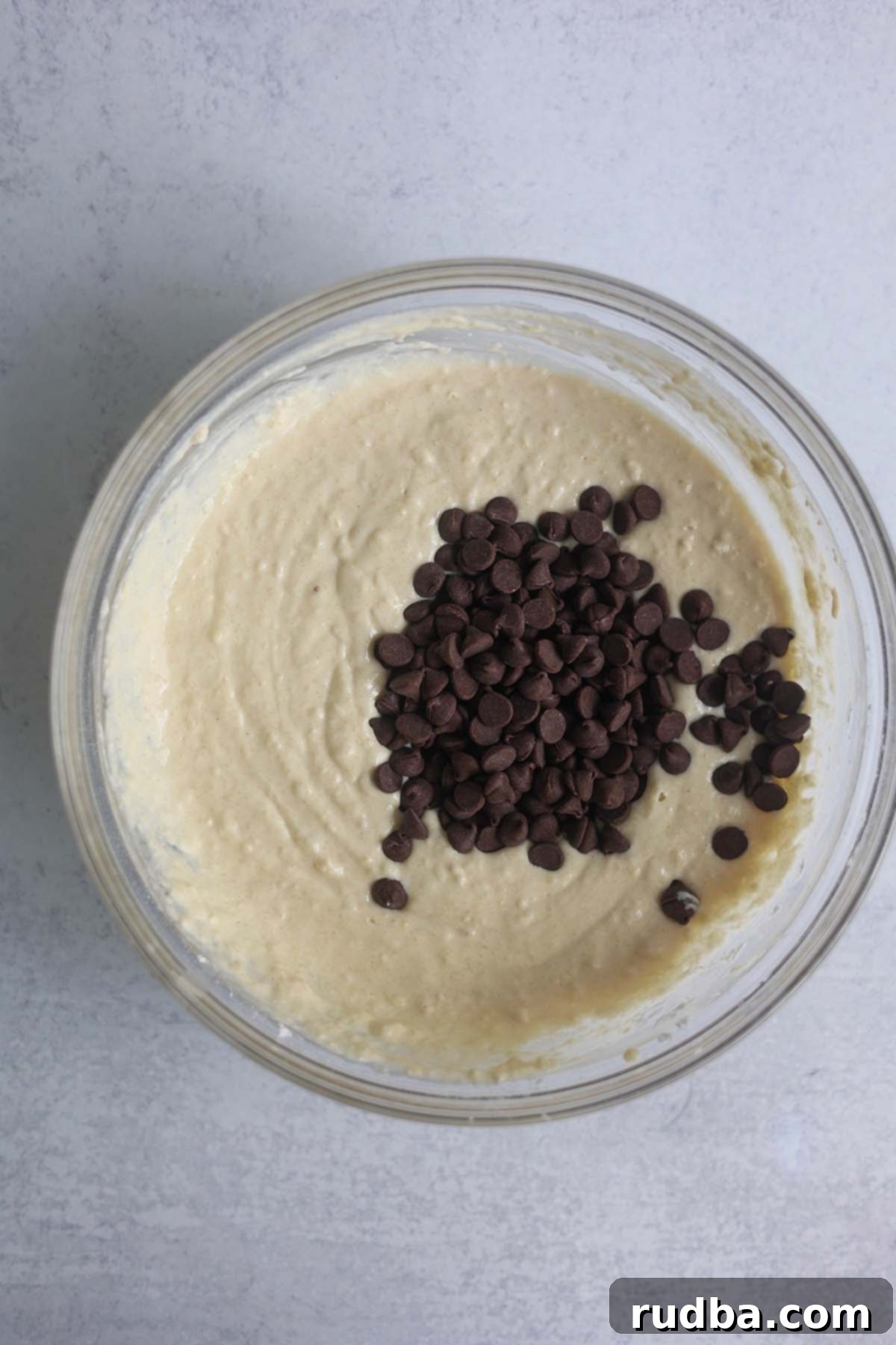 waffle batter with chocolate chips in a glass bowl.