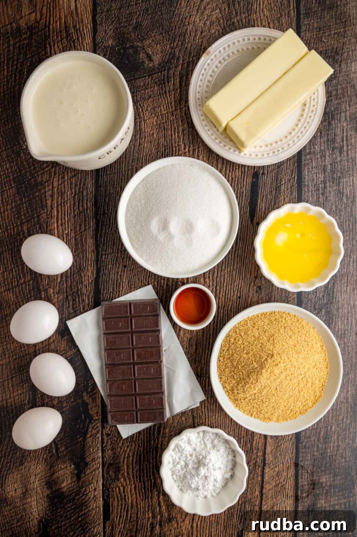Silky Chocolate Dream Pie 3 Various ingredients for French silk pie laid out on a dark surface, including chocolate, butter, eggs, and cream.