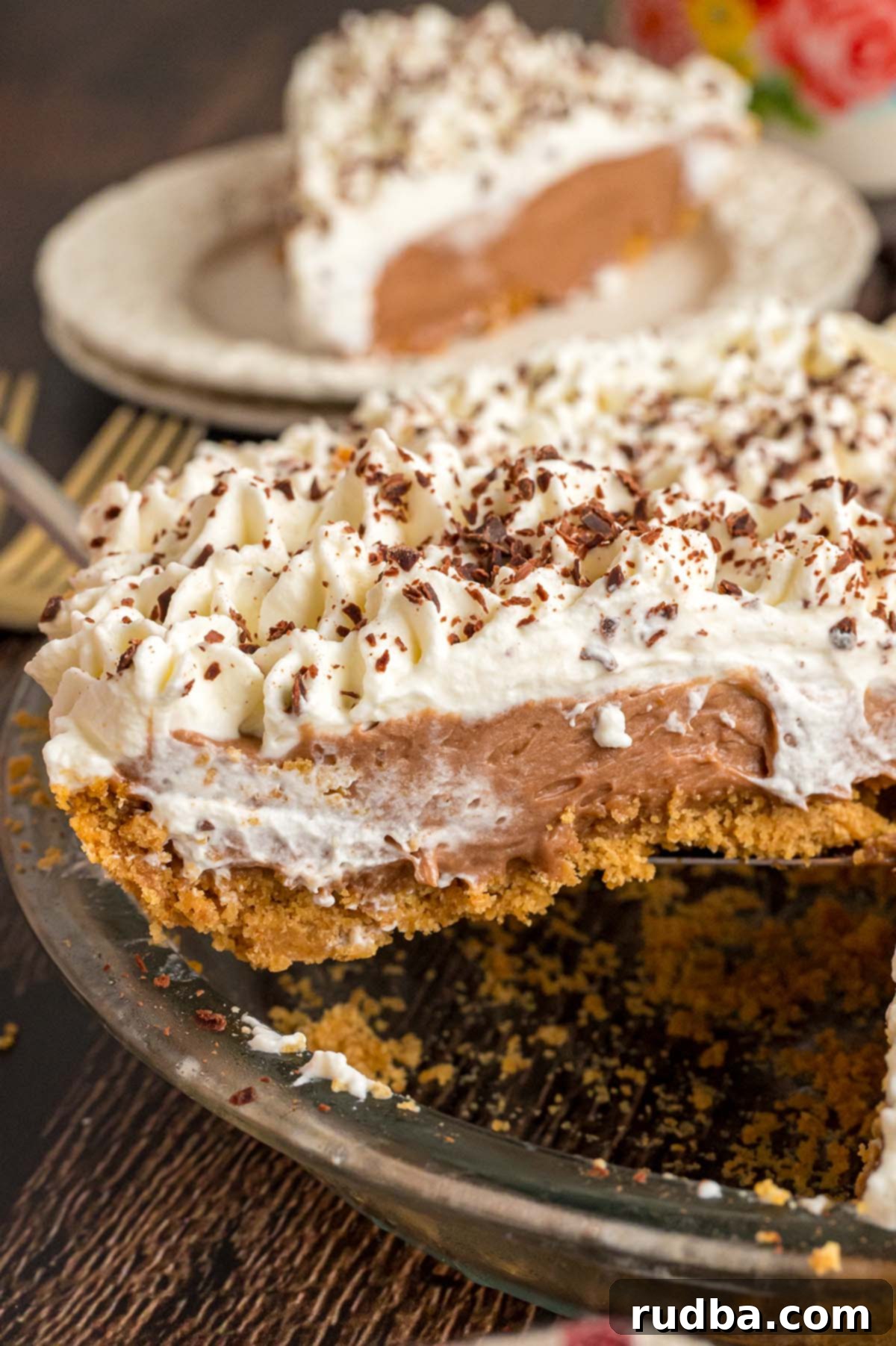 Silky Chocolate Dream Pie 5 A complete French silk pie nestled in a 9-inch pie dish, topped with a generous swirl of whipped cream.