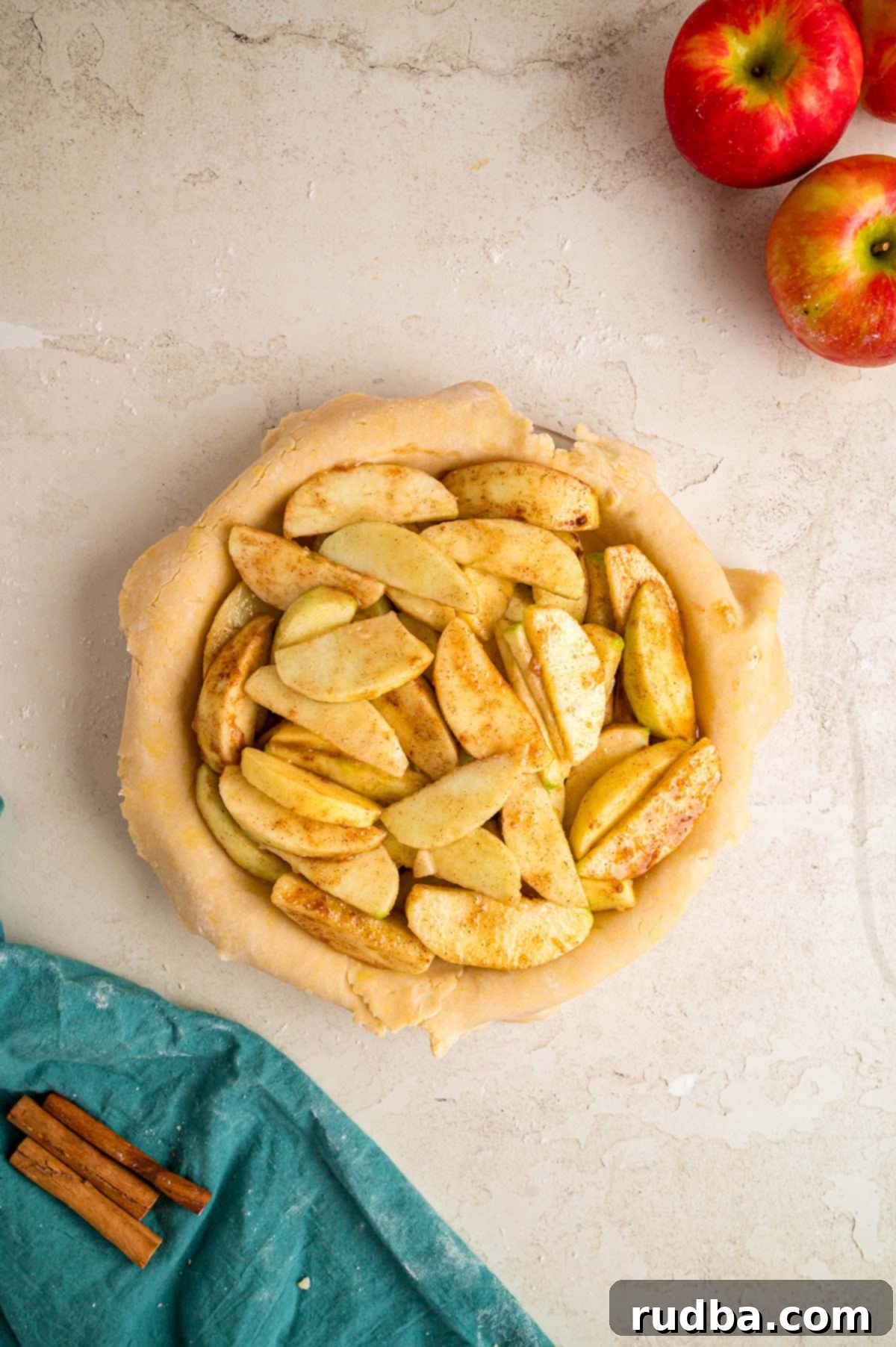 Warm Spiced Apple Pie 5 Sliced apples mixed with spices and sugar, resting in a pie shell, ready for the top crust.