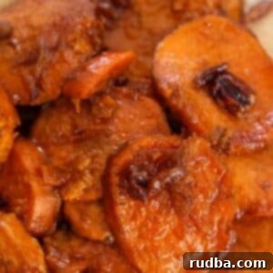 Bourbon-Kissed Sweet Potatoes 6 bourbon candied yams with pecans on top.