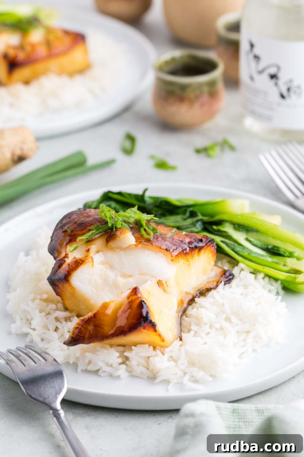 Savory Miso Glazed Chilean Sea Bass 5 Chilean sea bass on a plate with a fork on the side.