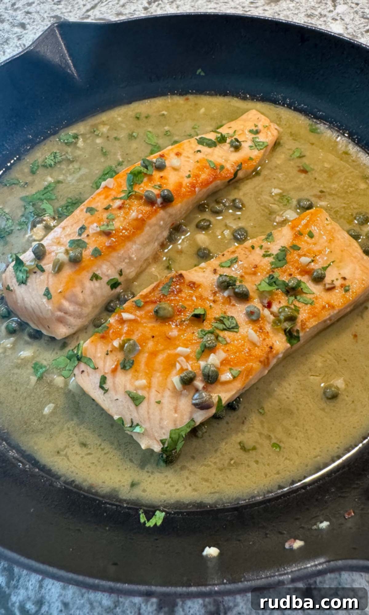 Salmon piccata in a cast iron skillet. 