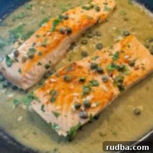 Salmon piccata in a cast iron skillet.