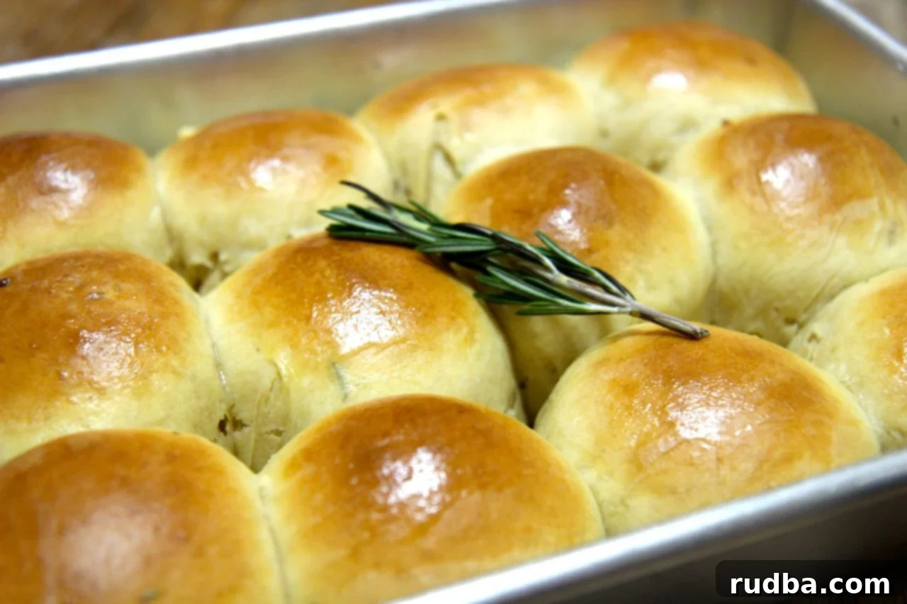 Golden brown rosemary garlic rolls brushed with melted butter, ready to be served