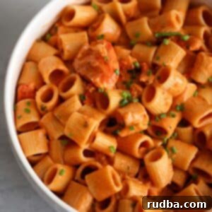 Decadent Lobster Pasta 5 Creamy lobster pasta in a white bowl.
