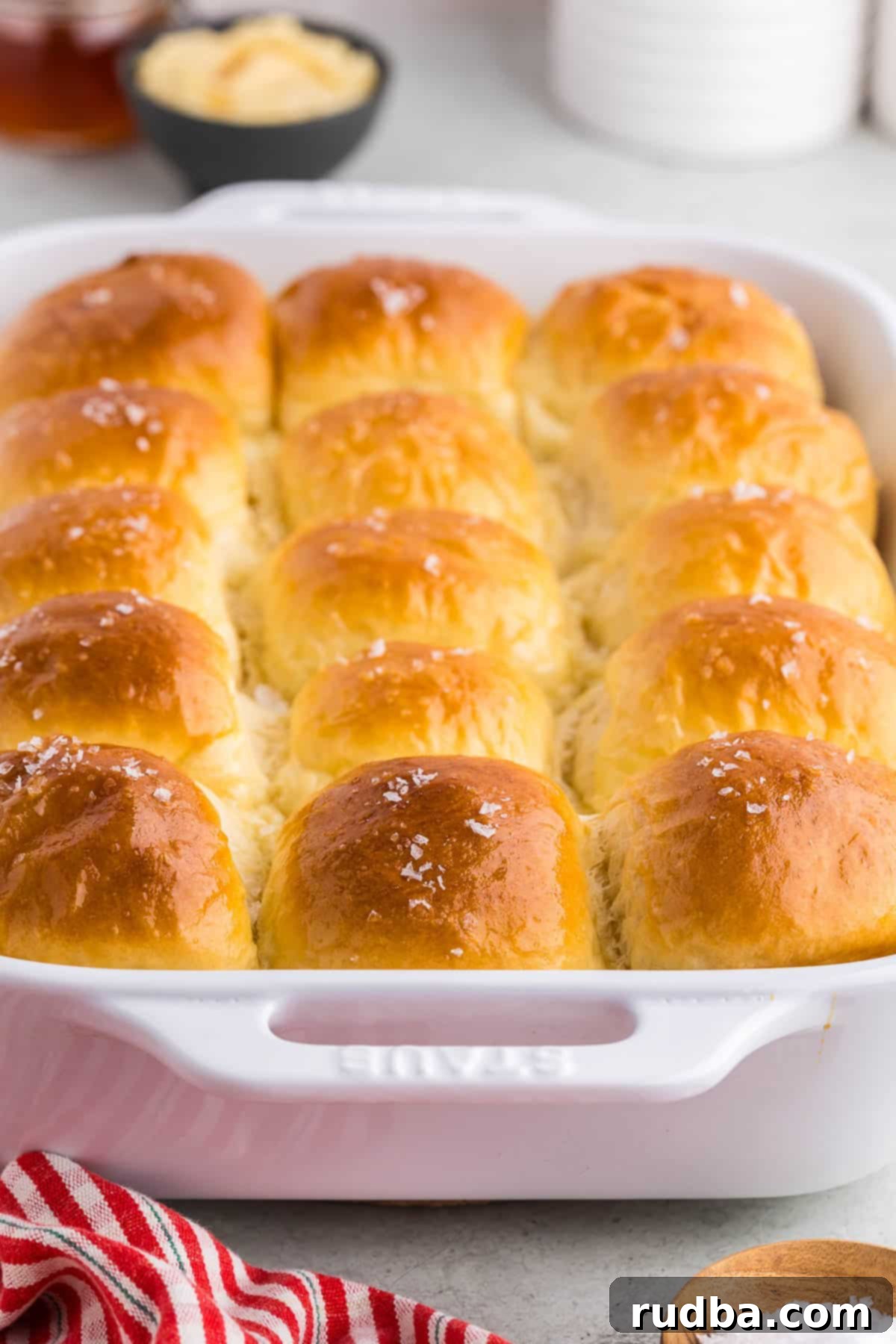 Baked parker house rolls with honey butter on the side.