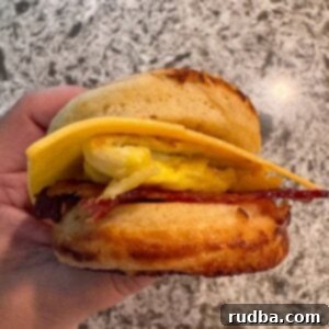 A hand holding a McGriddle sandwich.