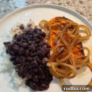 Zesty Cuban Pan-Seared Chicken 5 grilled chicken with onions on top with a side of rice and black beans.