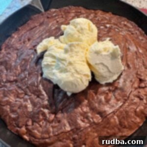 Warm Skillet Chocolate Brownie Bliss 5 Fudgy Chocolate Brownie Skillet served with vanilla ice cream, ready to enjoy.