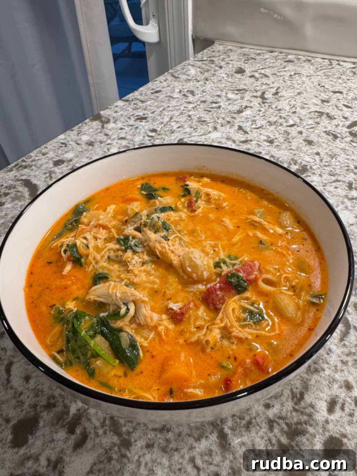 A small bowl of creamy Marry Me Chicken Noodle Soup garnished with fresh herbs, ready to be enjoyed.