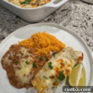 Ultimate Green Chile Chicken Enchiladas 5 Green Chile chicken enchiladas with yellow rice and refried beans.