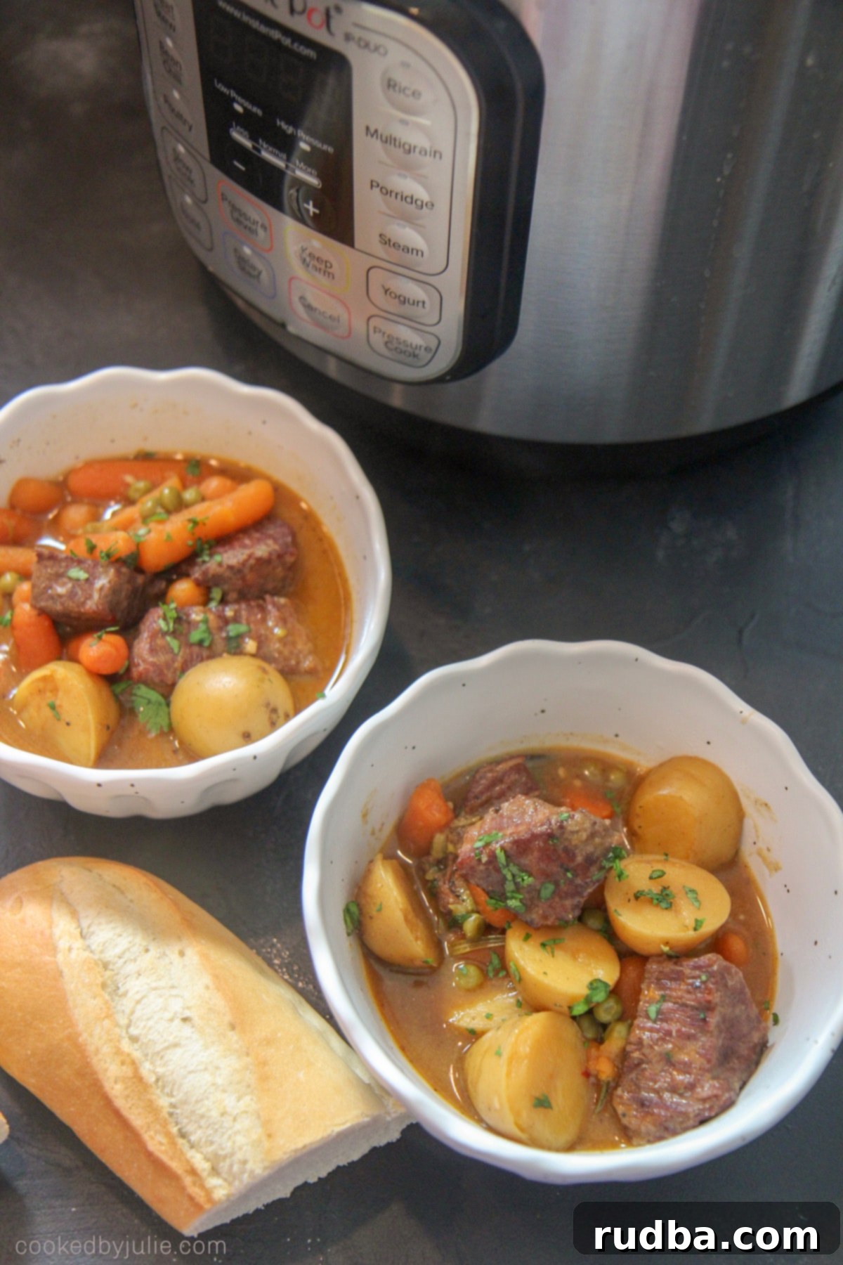 Two bowls of Instant Pot Beef Stew with crusty bread.