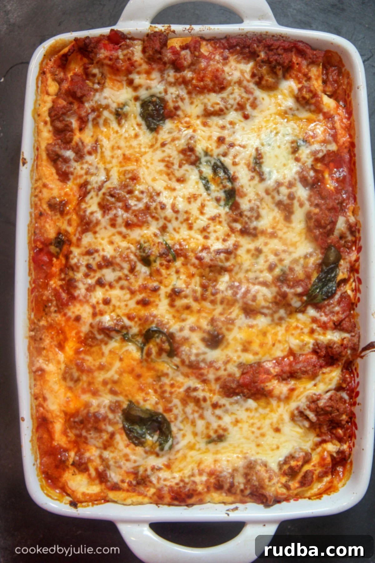 A whole Cajun Lasagna in a baking dish, ready to be served, showcasing its cheesy topping and rich layers.
