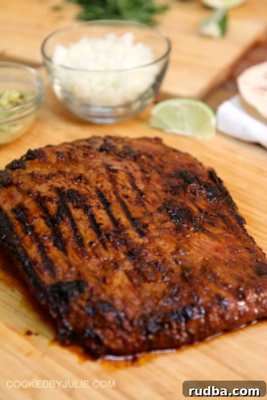 Grilling flank steak to a perfect medium-rare, allowing it to rest on a cutting board before slicing against the grain for the ultimate juicy and flavorful carne asada.