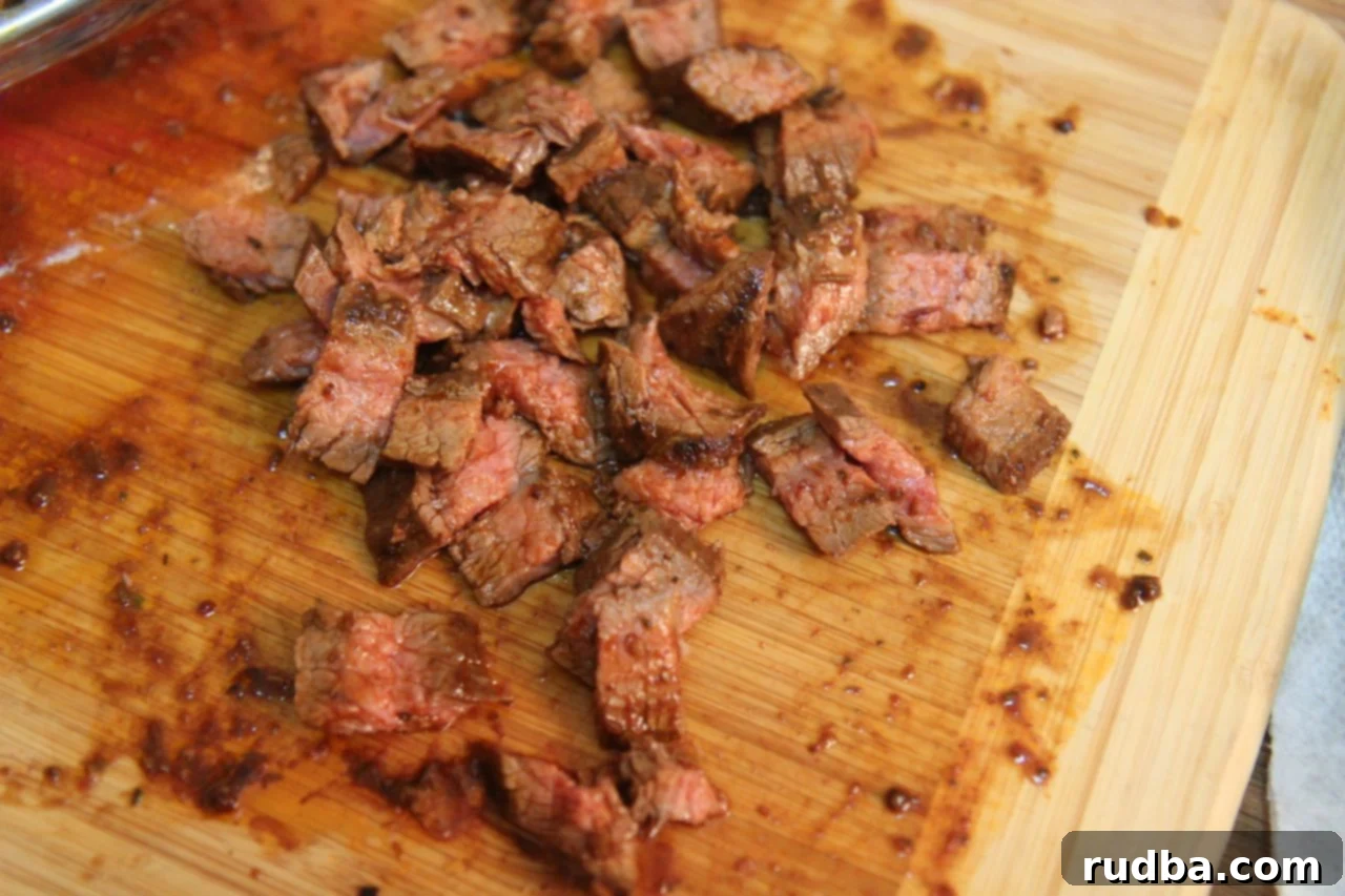 Perfectly cooked and rested flank steak, showcasing its juicy interior and charred exterior, sliced against the grain and ready for delicious carne asada tacos.
