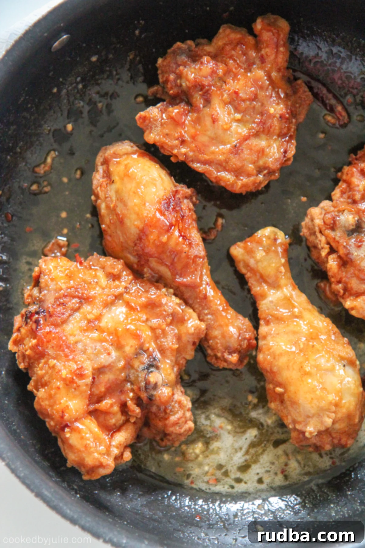 Crispy Honey Bone-in Fried Chicken coated in a glossy, golden honey butter sauce, ready to be served.