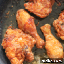 Honey Bone-in Fried Chicken with a golden, crispy crust and sweet glaze.