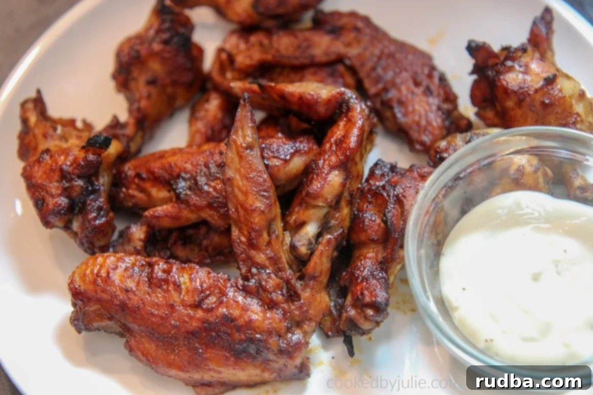 Platter of BBQ Instant Pot chicken wings served with a side of bleu cheese dressing.
