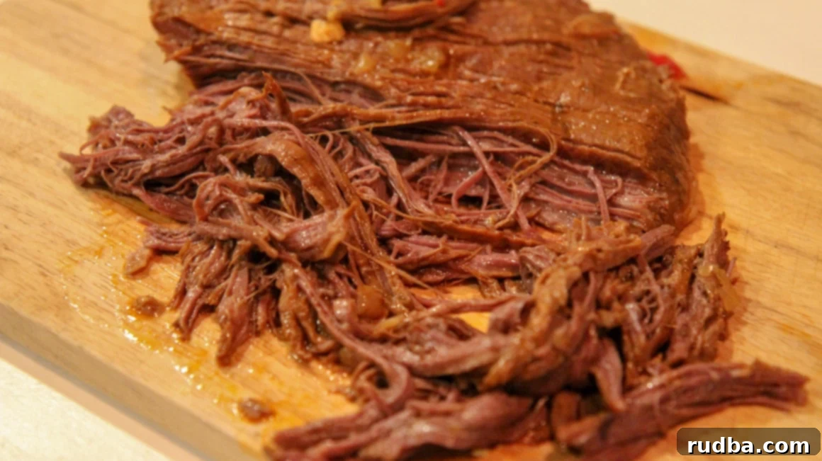Perfectly shredded flank steak in a flavorful tomato broth for Ropa Vieja