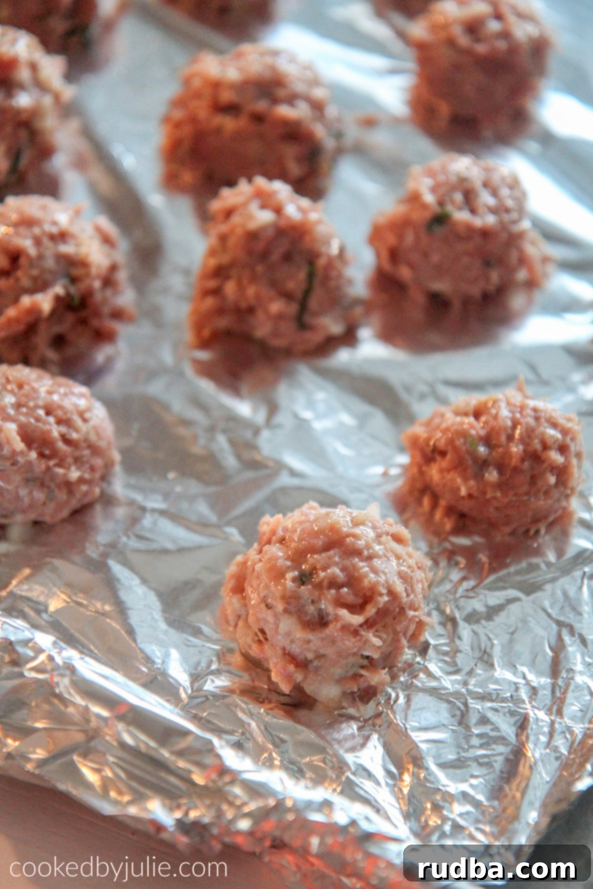 Turkey meatballs arranged neatly on a baking sheet, ready to be cooked.