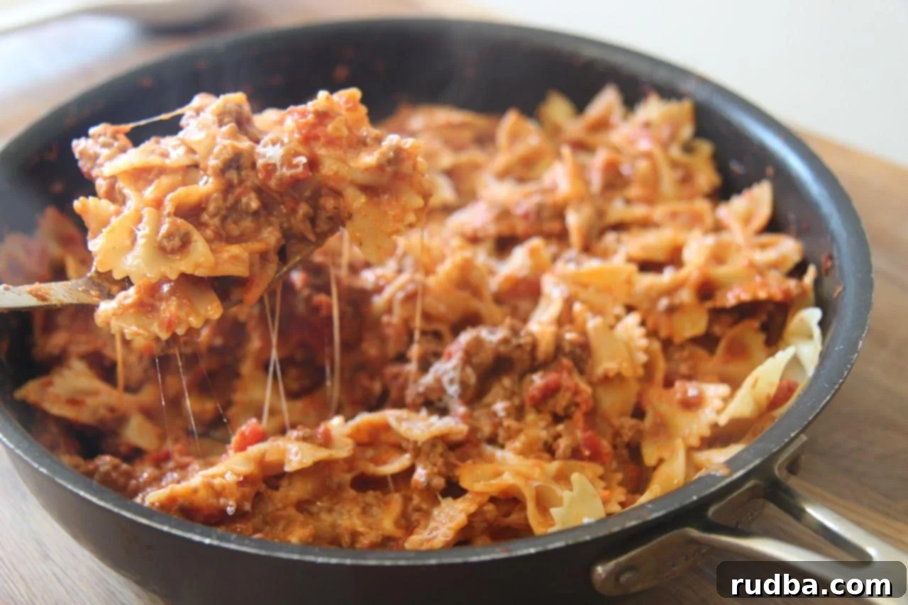 Bowtie pasta mixed with a spicy meat sauce and creamy cheese