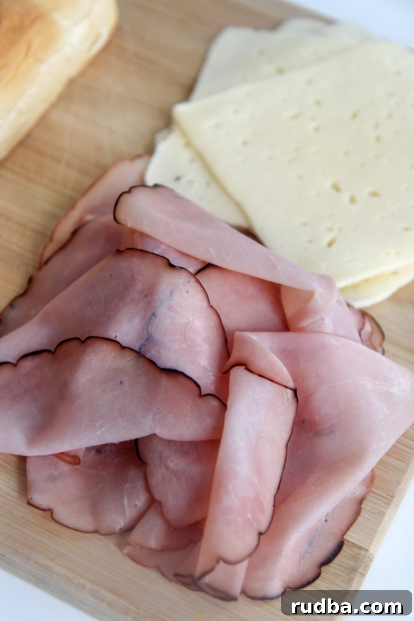 deli ham and cheese on a wooden board 