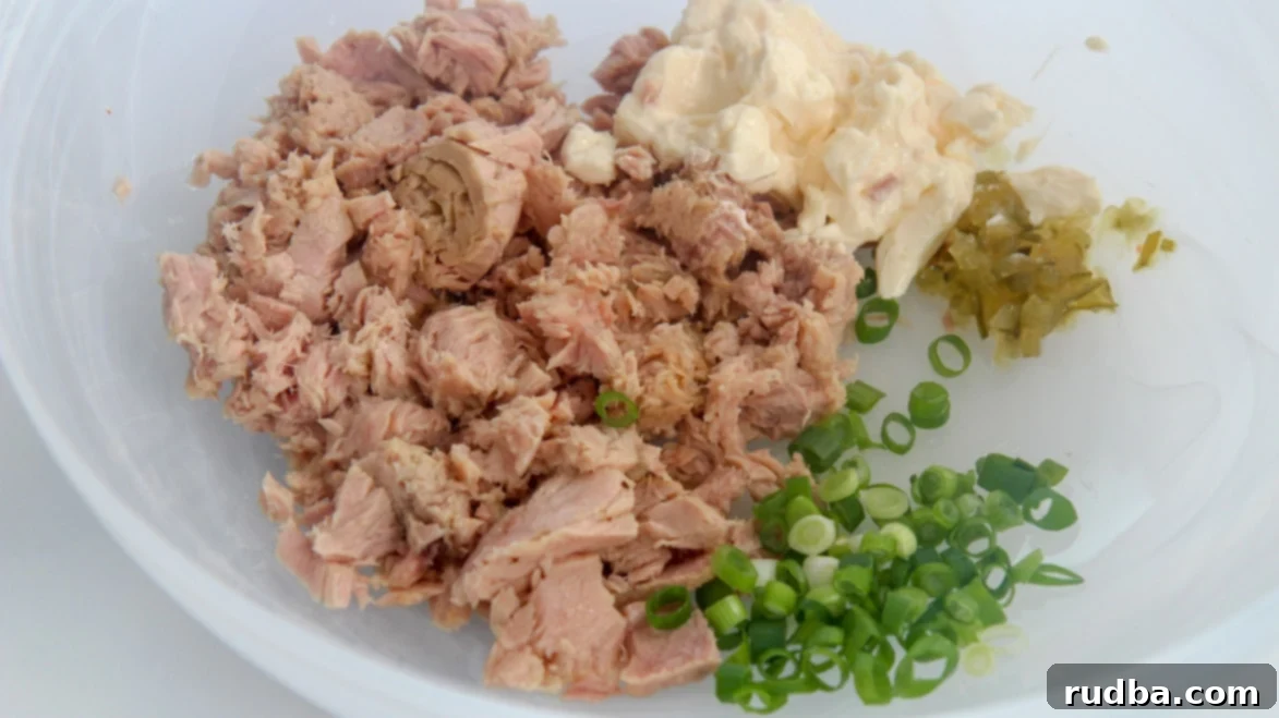 canned tuna, scallions, mayo, and sweet relish in a white bowl 